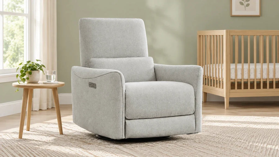 Light-gray Tracee recliner beside a wooden crib in a sage nursery