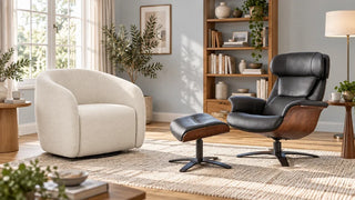 A cream Bella barrel chair beside a black leather Elvin lounge chair and ottoman in a reading room