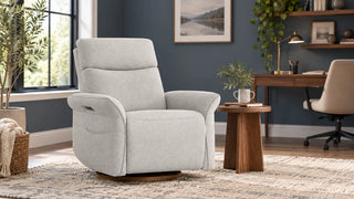 Light-gray Vinca recliner in a home-office reading corner beside a separate desk.