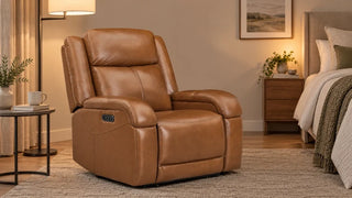 Tan Isaac recliner beside a lamp in a bedroom reading corner