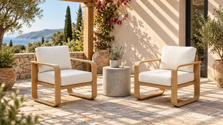 Two Dylan outdoor armchairs with pale cushions under a pergola
