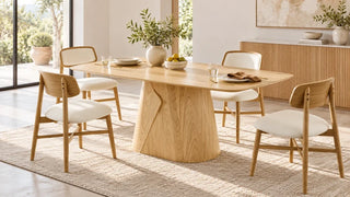 Elowen wood dining table with neutral chairs in a bright dining room.