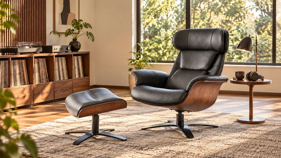 Black leather Elvin chair and separate ottoman beside record storage and a table with headphones.