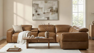 Brown leather sectional with a chaise in a sunlit living room.