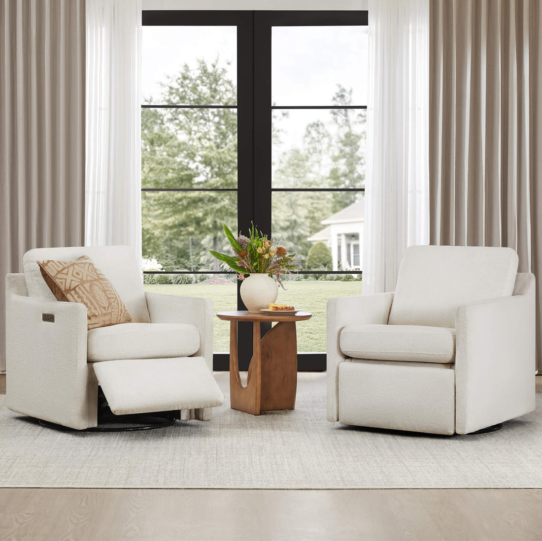 Henry Swivel Accent Chair with Electric Footrests & Charging Ports - Two Henry Power Swivel Recliner chairs in a bright room with a large window.