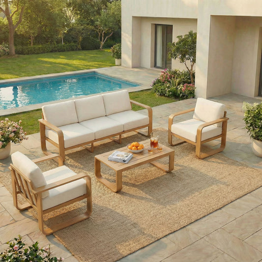 A luxurious modular outdoor seating arrangement by the pool, including a spacious three-seater wooden sofa, two matching armchairs, and a coffee table resting on a woven outdoor rug.