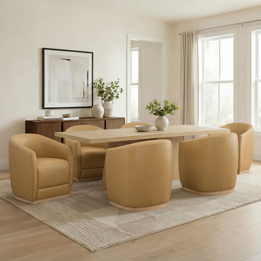 Curved dining chair with arms and a rolling base in a dining room setting