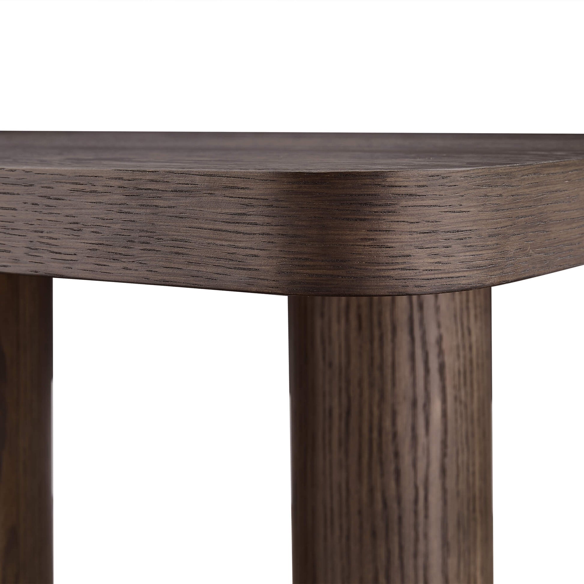 Close-up of a dark brown oak wood console table with a thick, rounded edge and cylindrical legs.