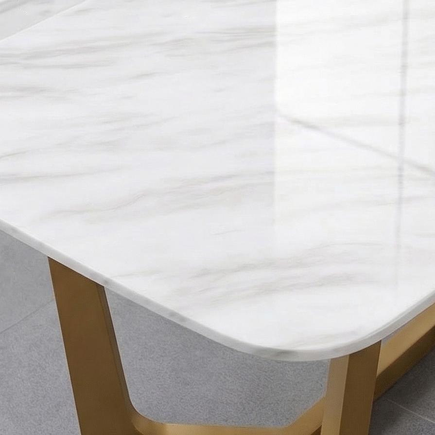 White marble dining tabletop with grey veining, champagne stainless steel U-shaped base.