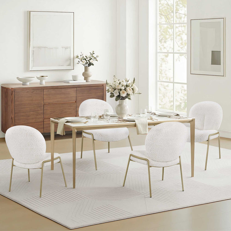 63" Teresa rectangle sintered stone dining table with gold metal base and white boucle chairs.