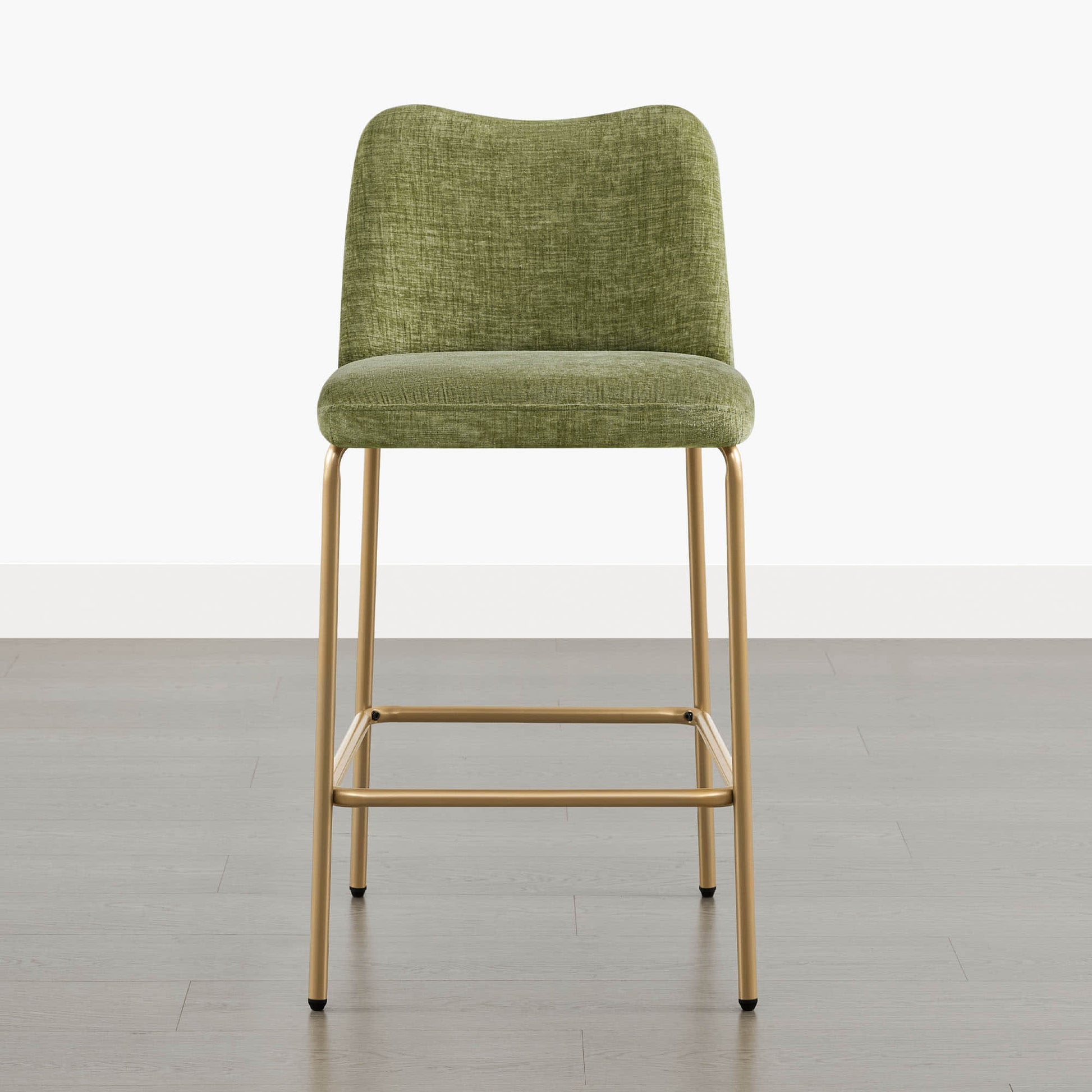 Green upholstered barstool with gold metal base and footrest