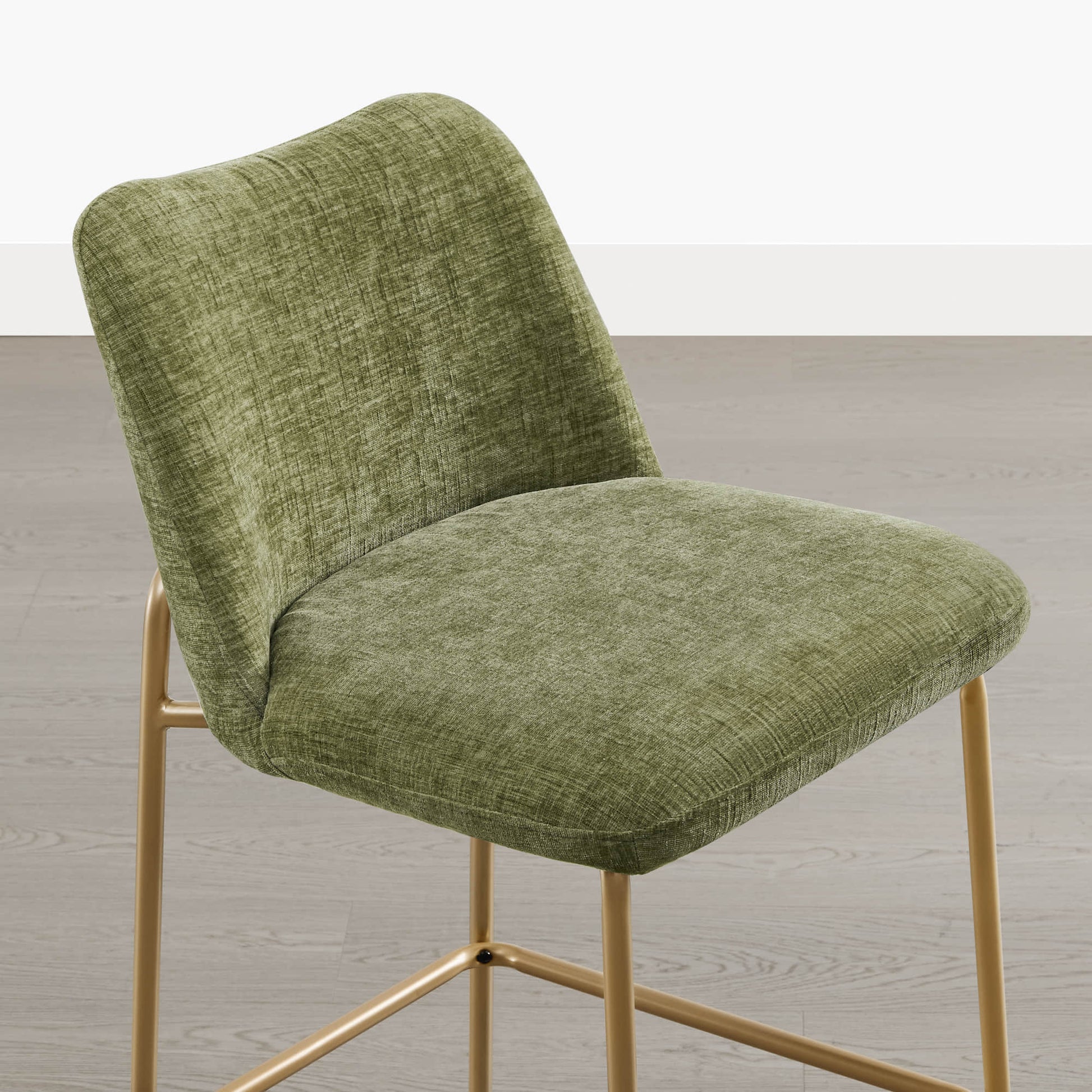 Amalia green upholstered barstool with gold metal base and curved back