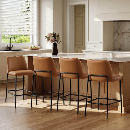 Amalia modern metal base barstool with tan upholstered seat, black frame, and low back at kitchen island