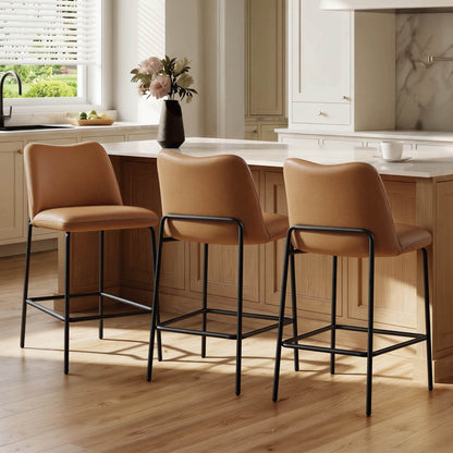 Amalia modern metal base barstools with tan upholstered seats and black frames at a kitchen island