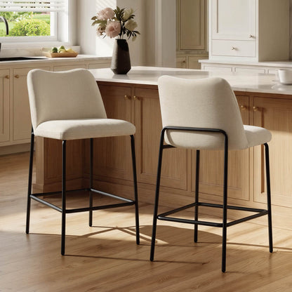 Beige upholstered barstools with black metal base in a modern kitchen