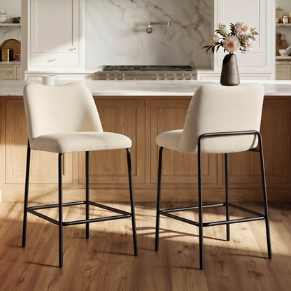 Cream upholstered Amalia modern barstools with black metal bases in a kitchen