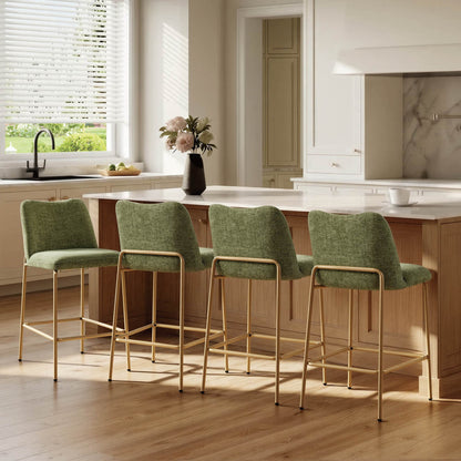 Green upholstered barstools with gold metal bases beside a kitchen island