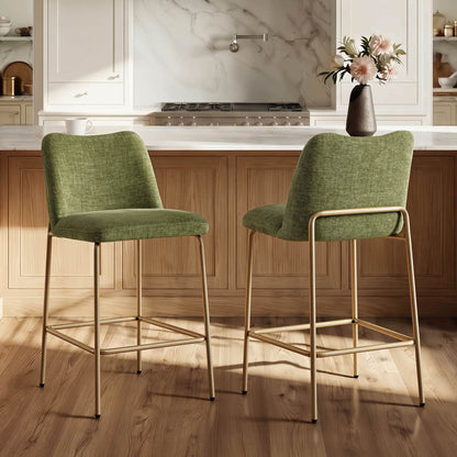 Green upholstered barstools with gold metal base in a modern kitchen