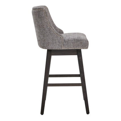 Side view of Asher swivel stool in gray fabric with silver nailhead trim and wooden legs - CHITA Living