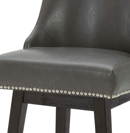 Close-up of Asher swivel bar stool in dark gray faux leather with silver nailhead trim - CHITA Living