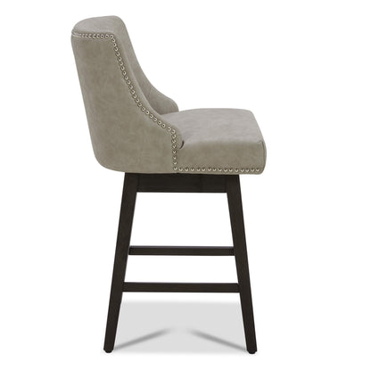 Side view of gray Asher swivel bar stool with silver nailhead trim on wooden legs - CHITA Living