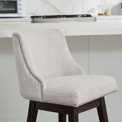 Close-up of light beige Asher swivel stool with silver nailhead trim in modern kitchen - CHITA Living