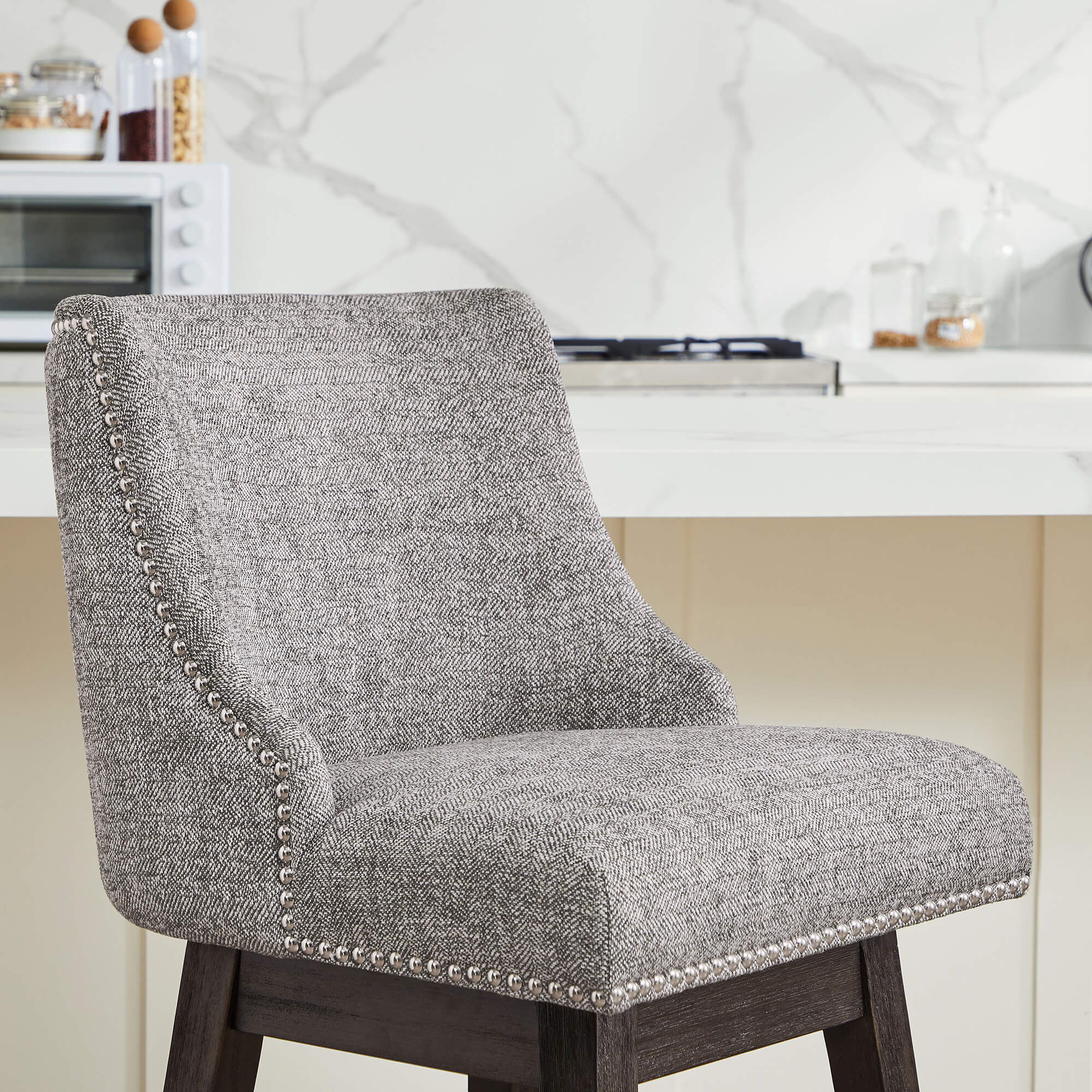 Gray Asher swivel bar stool with herringbone fabric and silver nailhead trim in kitchen - CHITA Living