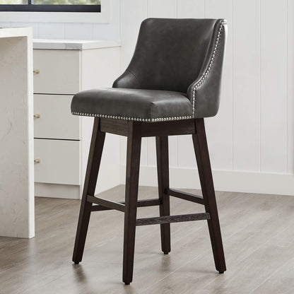 Asher swivel bar stool in dark gray upholstery with silver nailhead trim and wooden legs - CHITA Living