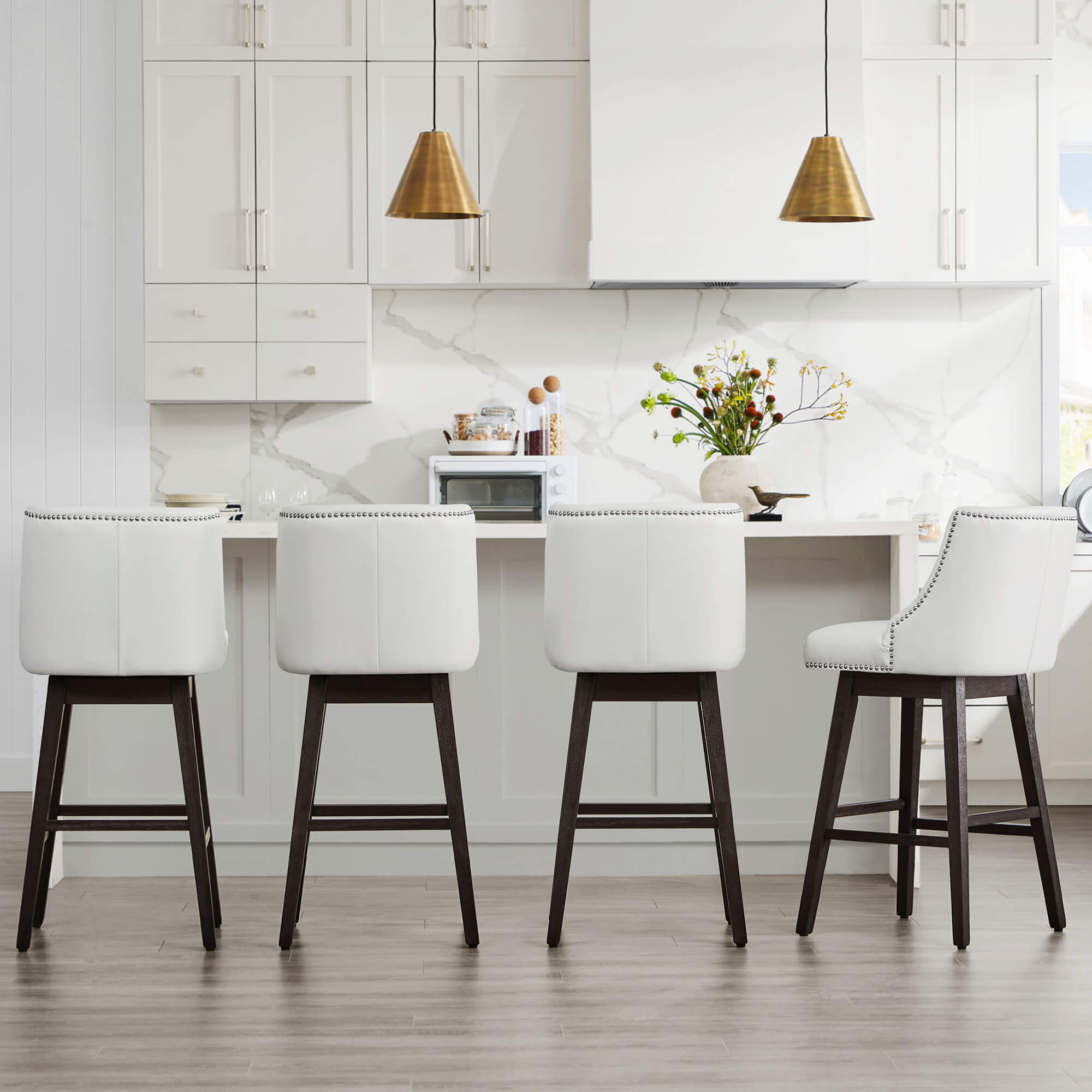 White Asher swivel bar stools with nailhead trim in a modern kitchen setting - CHITA Living