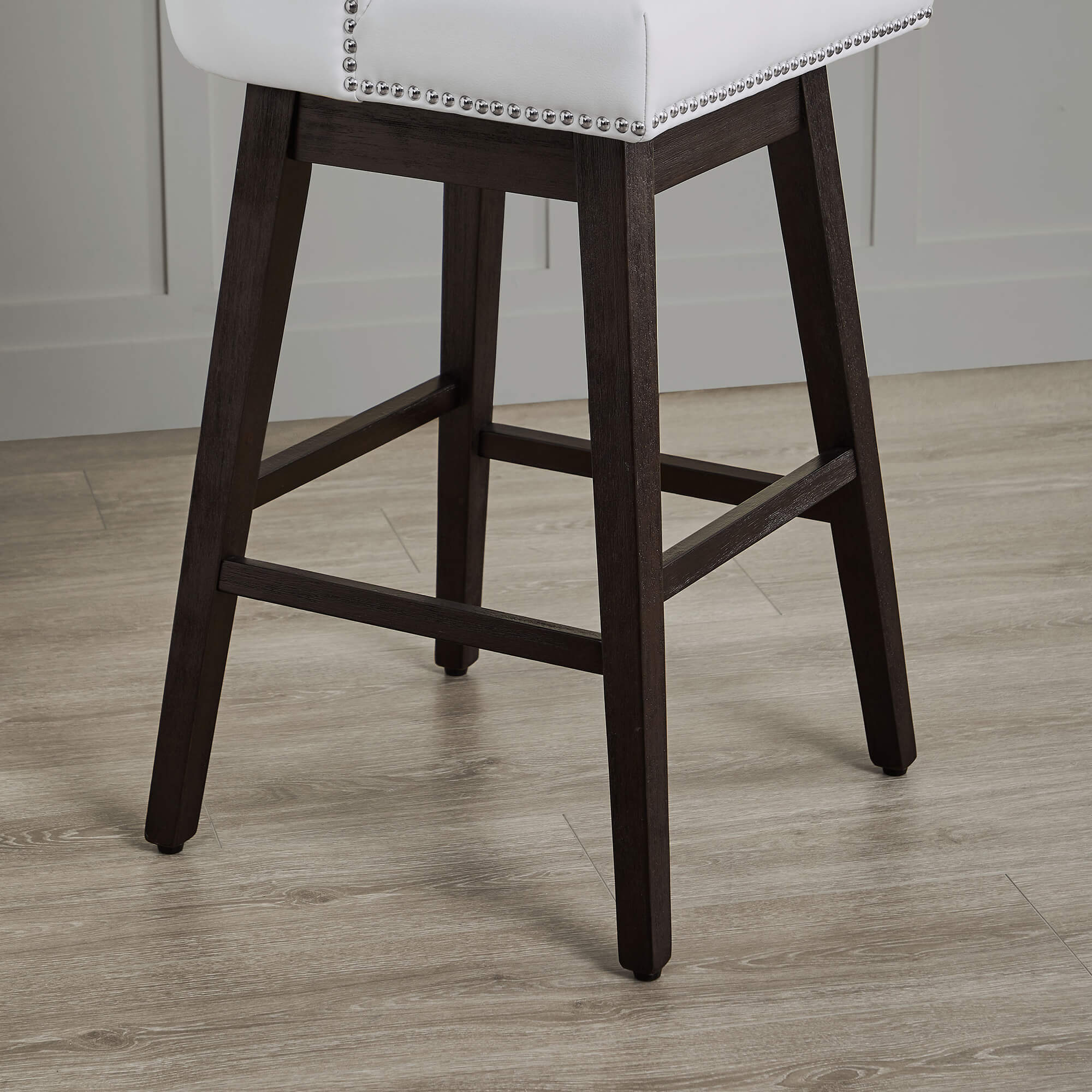 Close-up of Asher swivel bar stool with white upholstery and silver nailhead trim - CHITA Living