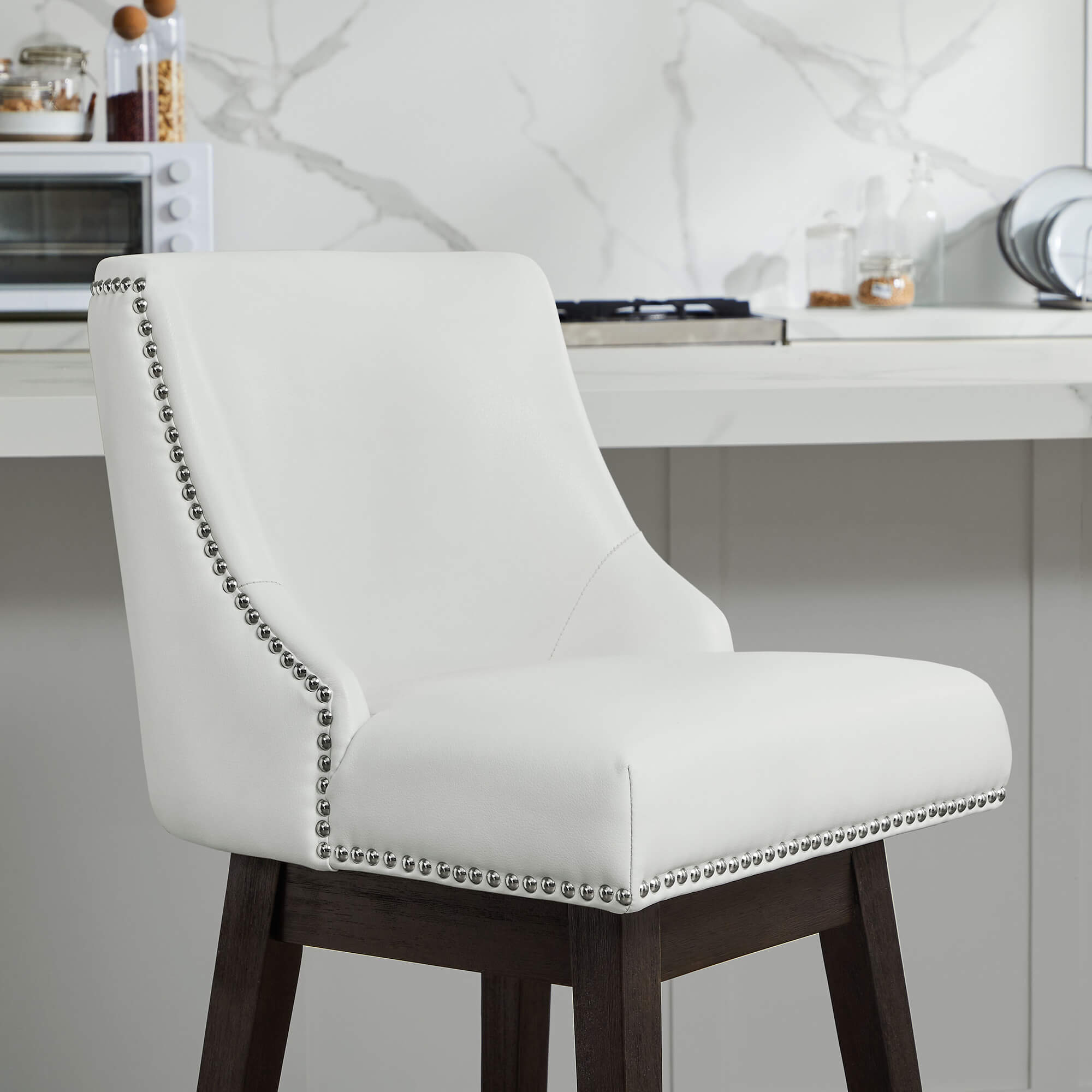 Asher swivel bar stool in white upholstery with silver nailhead trim in contemporary kitchen - CHITA Living