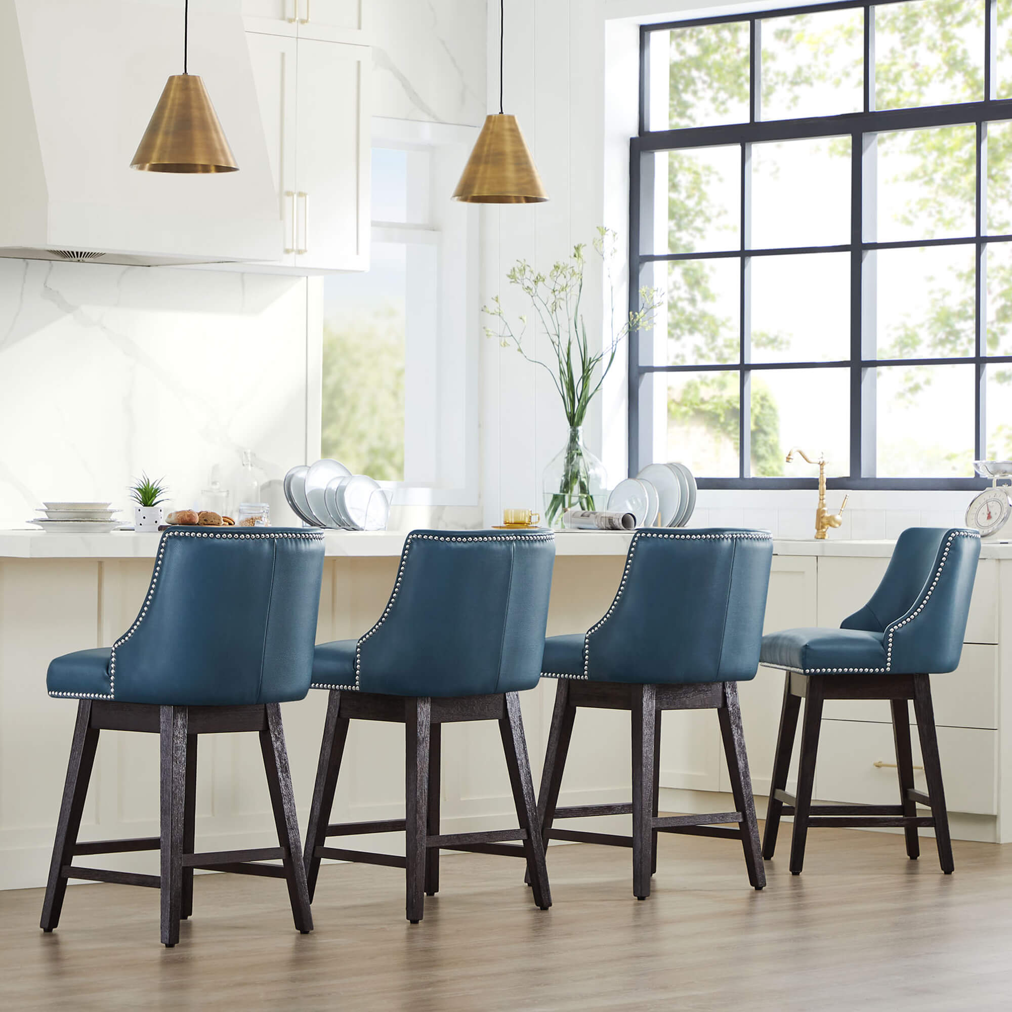 Teal Asher swivel bar stools with nailhead trim in a contemporary kitchen setting - CHITA Living