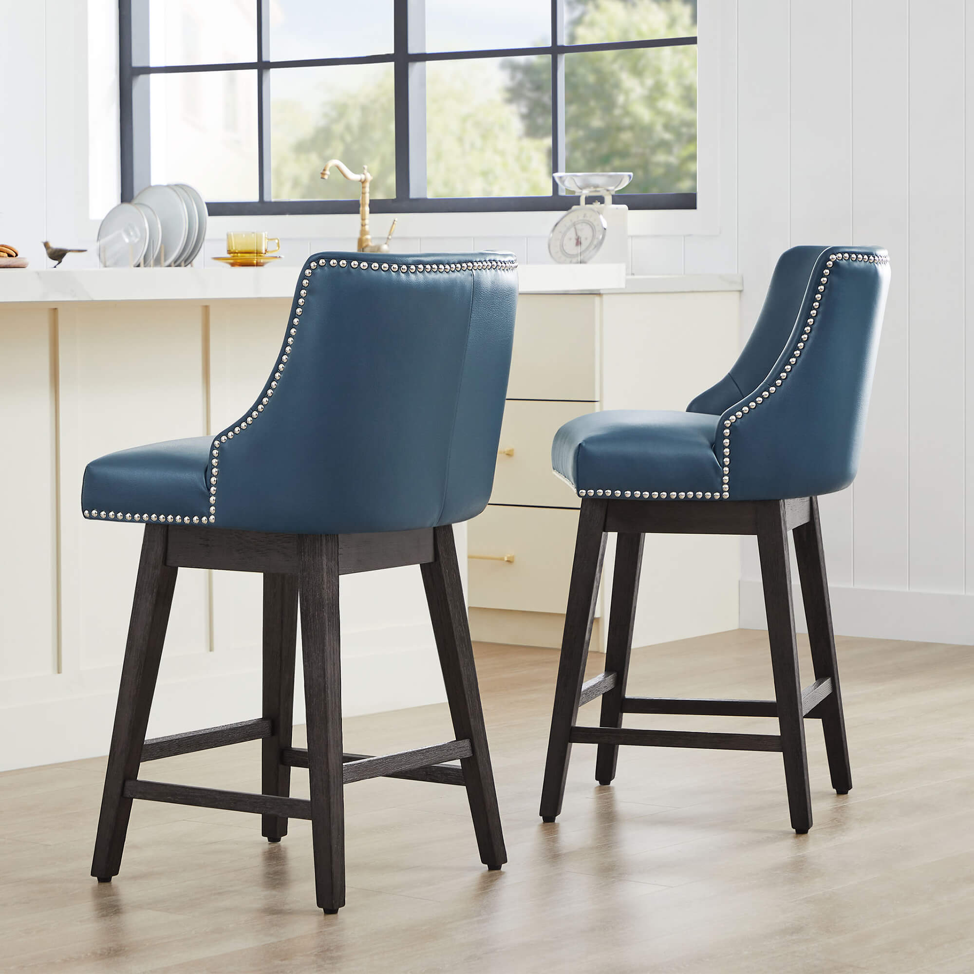 Teal Asher swivel bar stools with silver nailhead trim in a modern kitchen - CHITA Living