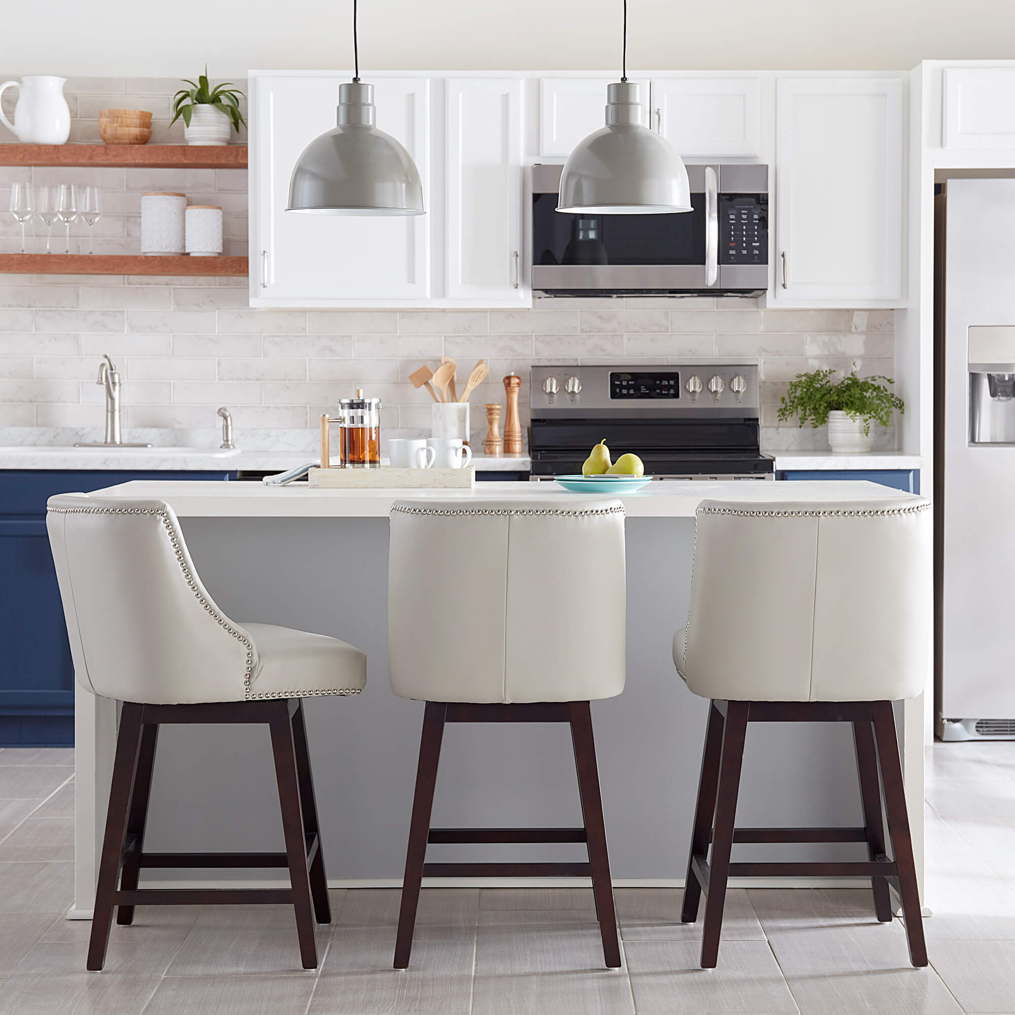 Asher swivel bar stools with silver nailhead trim in a modern light kitchen - CHITA Living