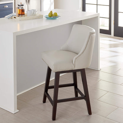 Asher swivel counter stool with cream upholstery and silver nailhead trim at a kitchen island - CHITA Living