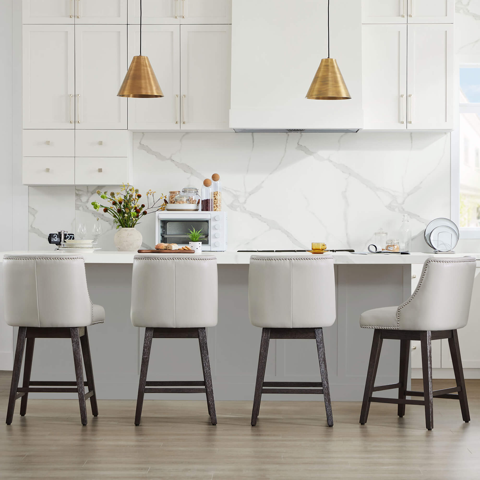 Asher swivel bar stools with silver nailhead trim in modern kitchen with marble backsplash - CHITA Living