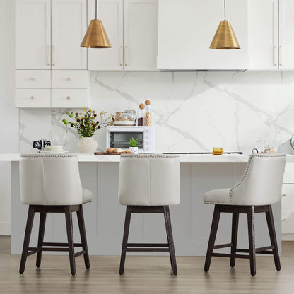 Asher swivel bar stools in light cream upholstery with silver nailhead trim at modern kitchen island - CHITA Living