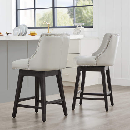 Asher swivel bar stools in light gray upholstery with silver nailhead trim at a kitchen island - CHITA Living