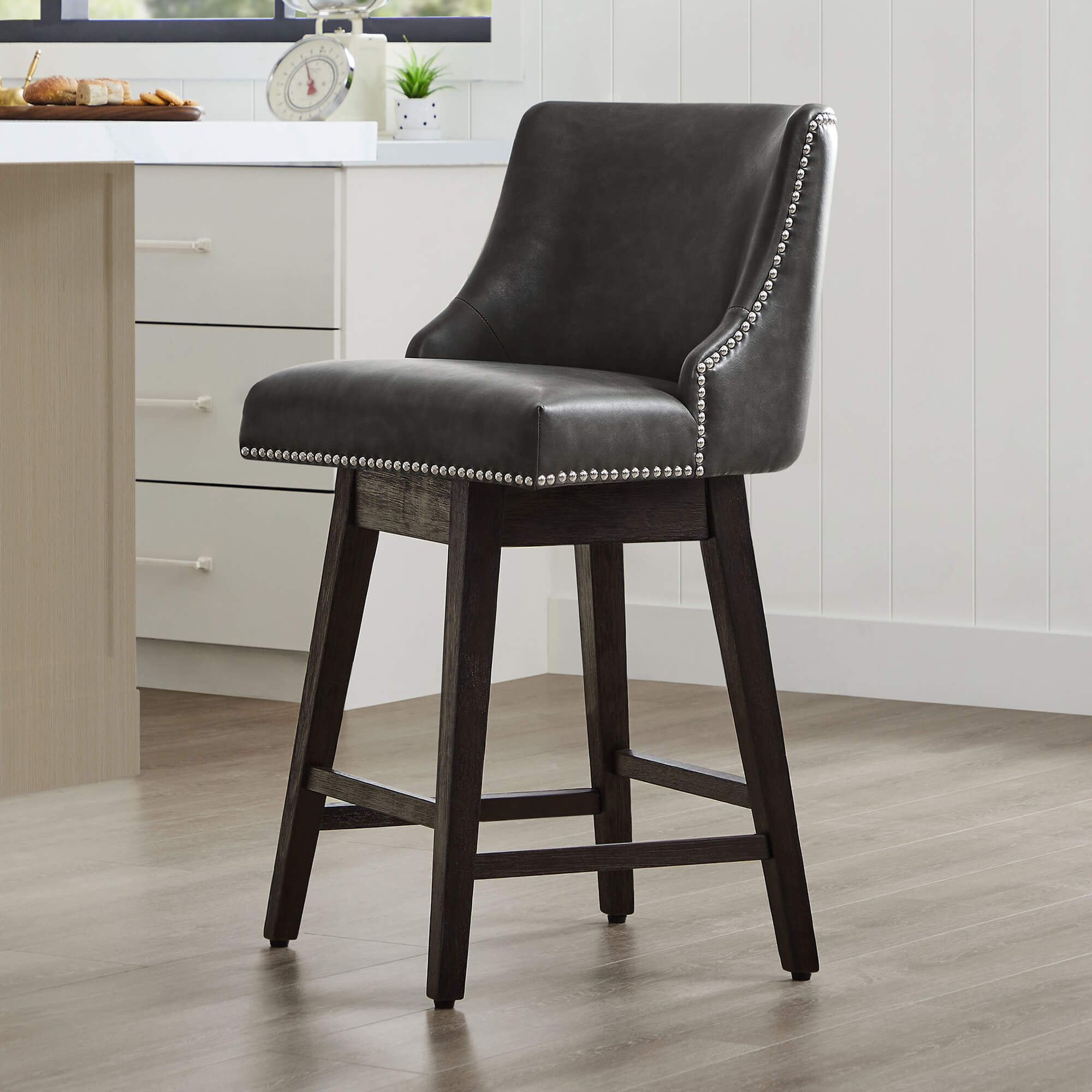 Asher swivel bar stool in dark gray upholstery with silver nailhead trim - CHITA Living