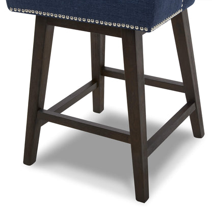 Navy Asher swivel bar stool close-up with silver nailhead trim on dark wood legs - CHITA Living