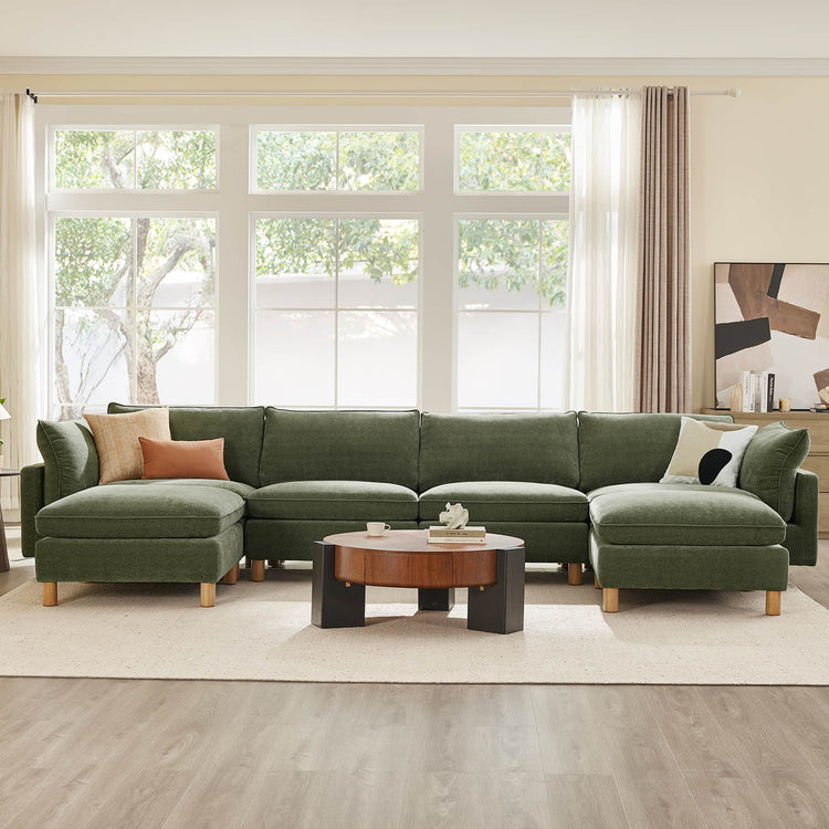 Green 6-seat modular sectional sofa with wood legs and textured fabric, featuring comfortable seating and decorative pillows.