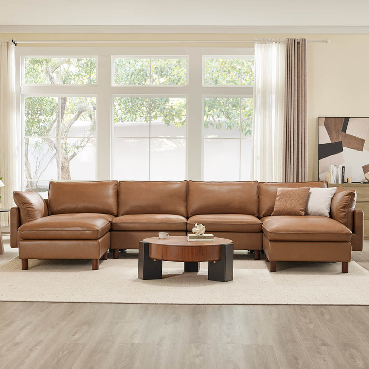 Brendon 6-seat modular sectional sofa in saddle brown top-grain leather with wood legs and round coffee table.