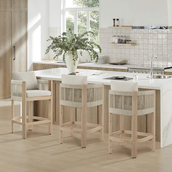 Three Clover Boho acacia wood rope counter stools with neutral cushions at modern kitchen island.