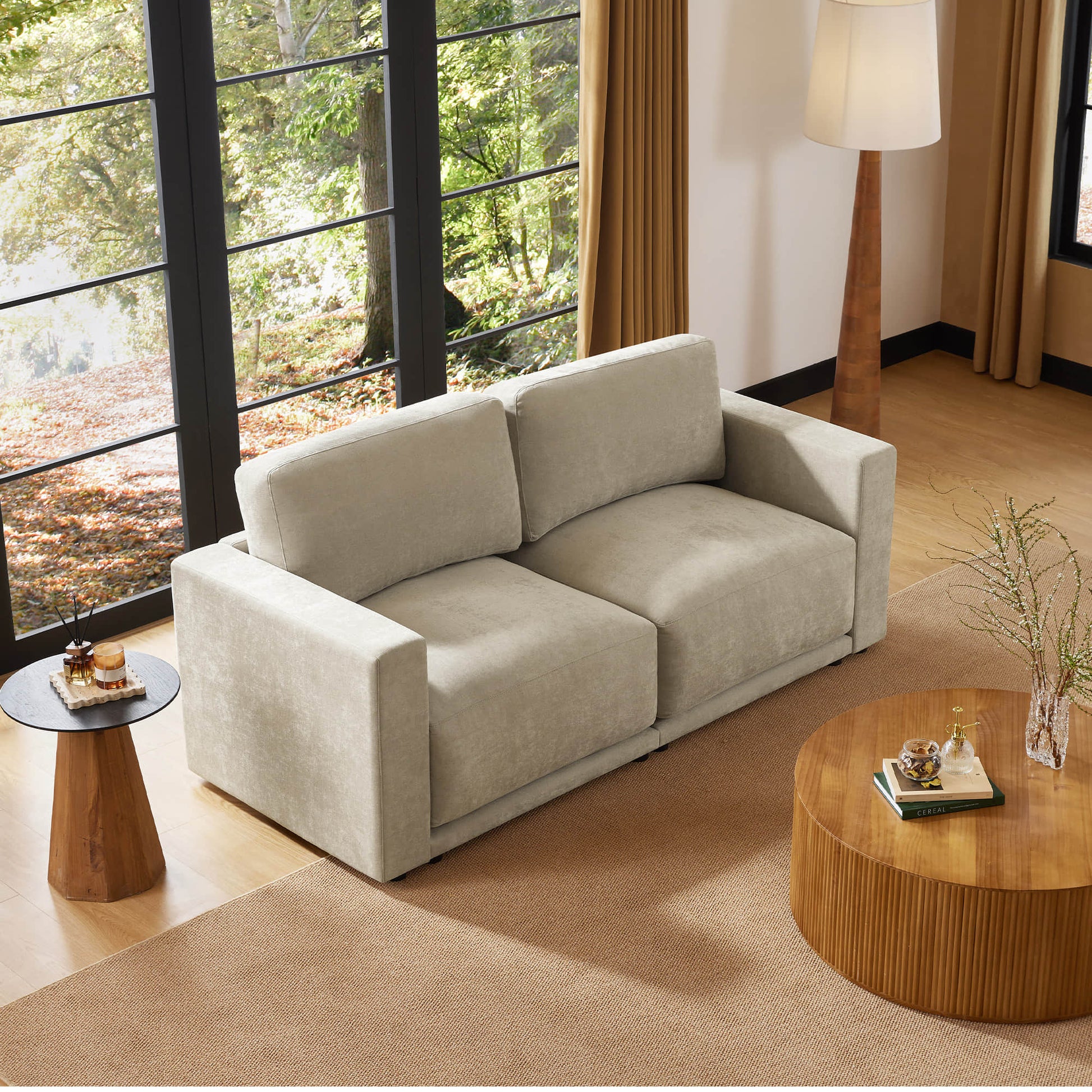 Comfortable two-seater sofa with a decorative pillow, adding a touch of style