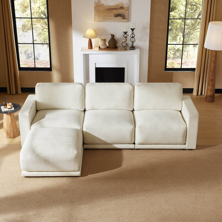 Elegant sectional sofa with chaise in a bright living room featuring a fireplace and decorative accents.