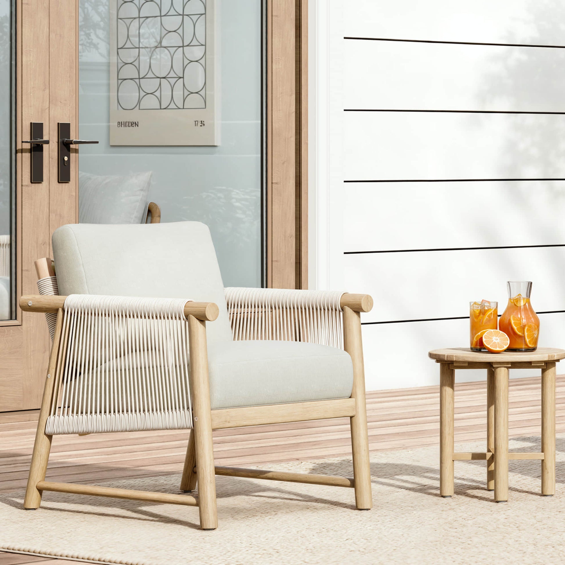A Sienna Modern Acacia Wood Woven Outdoor Bistro Set, featuring a chair and side table with lemonade, set on a patio.