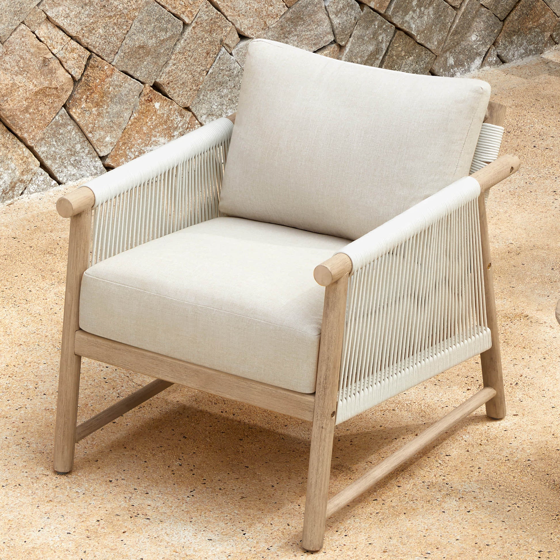 A Sienna Modern Acacia Wood Woven Outdoor Bistro Set chair with cushions
