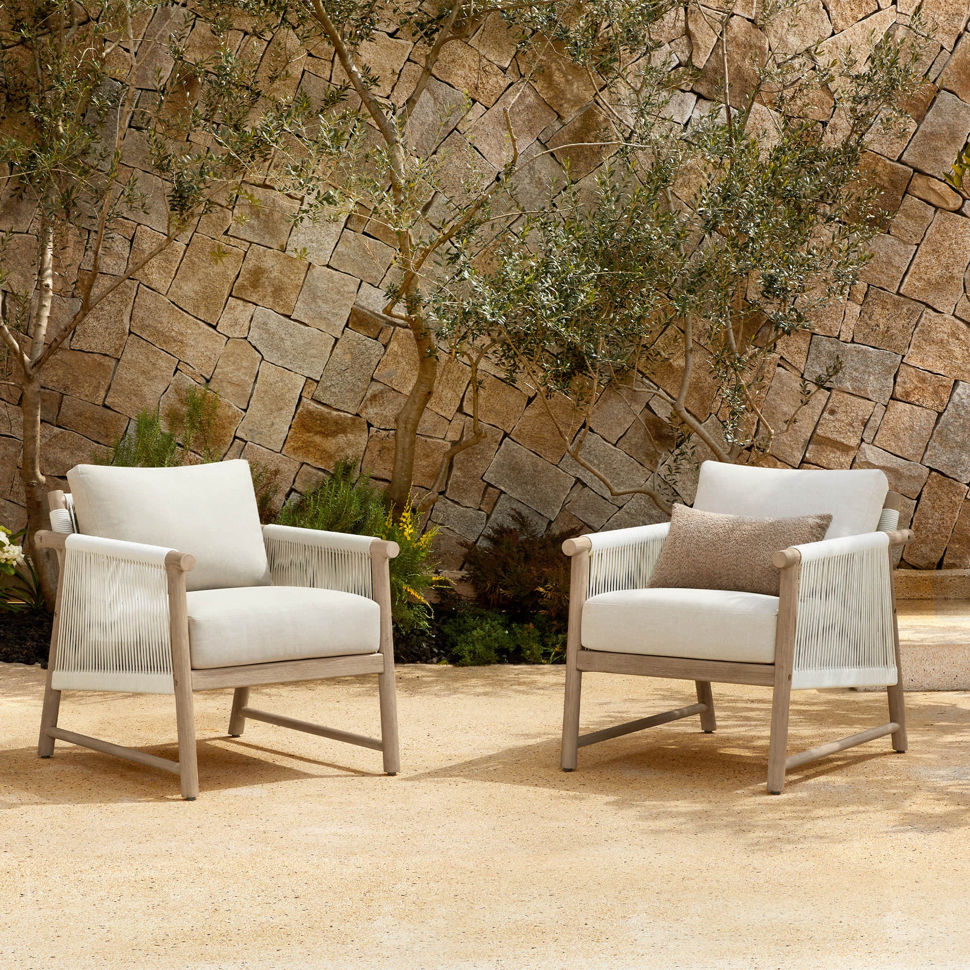 Two Sienna Modern Acacia Wood Woven Outdoor Bistro Set chairs with light beige cushions