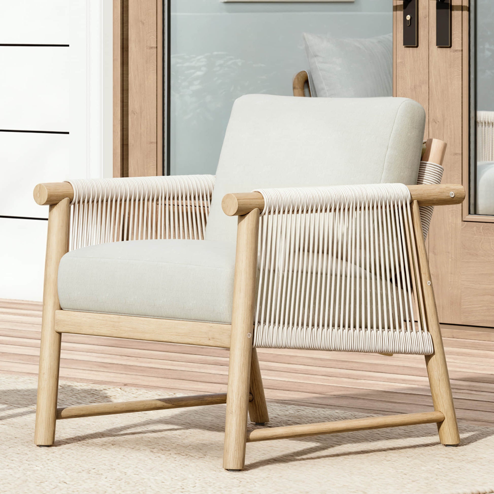 A Sienna Modern Acacia Wood Woven Outdoor Bistro Set chair with cream cushions, placed on a patio.