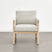 A Sienna Modern Acacia wood woven outdoor lounge chair with light beige cushions, set on a gray floor.